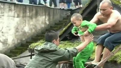 Small boy being lifted to safety