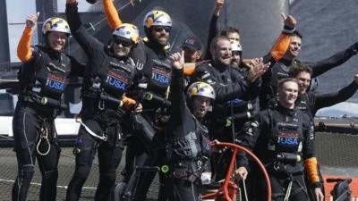 Oracle Team USA crew, including skipper Jimmy Spithill and tactician Sir Ben Ainslie, celebrate after winning the 19th race against Emirates Team New Zealand