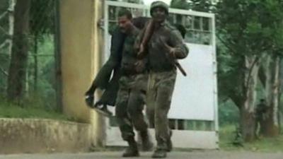 Injured man being carried from army base