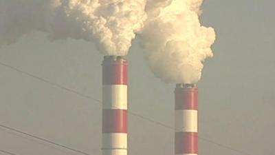 Industrial chimneys churning out clouds of gas