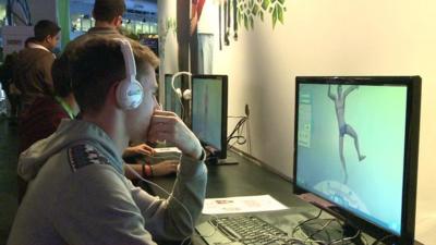 A man on a computer at the UK's biggest international video games show