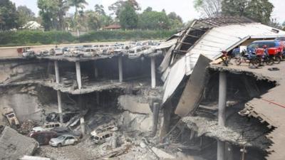 The remains of cars and other debris can be seen in a general view photographed from the rooftop, of the parking lot outside the Westgate Mall