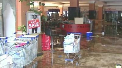 Trolleys inside damaged shopping mall