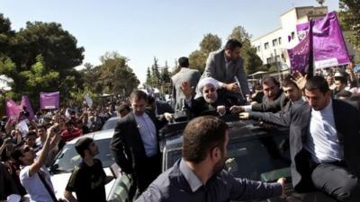 Iranian President Hassan Rouhani waves to supporters in Tehran