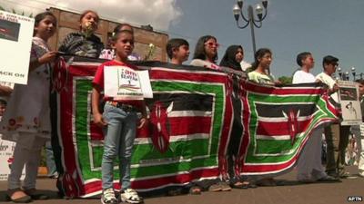 Nairobi's Asian Muslim community join hands for a human chain around the Westgate mall