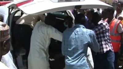 Family members gather outside a vehicle carrying a corpse in Damaturu on 29 September