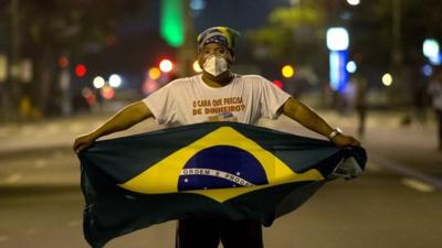 A man holds a Brazilian flag during a teachers strike in Rio De Janeiro