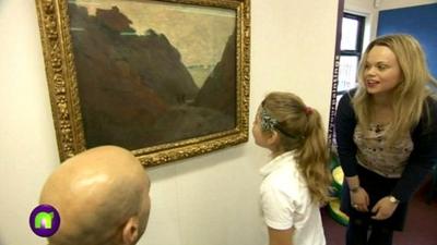 A girl looks at art by Monet