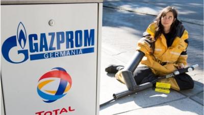 Greenpeace protester at Gazprom fuel station in Berlin