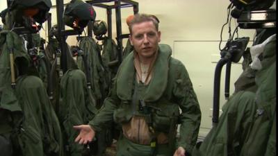 Flight Lieutenant Al Spence surrounded by kit