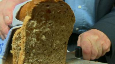 Loaf of bread being cut