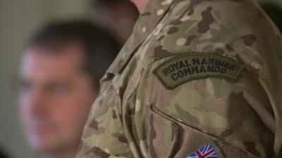 Man's shoulder displaying 'Royal Marine Commando' badge