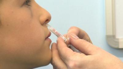 Child being given flu vaccine