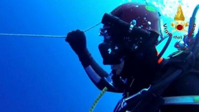 A diver searches for survivors