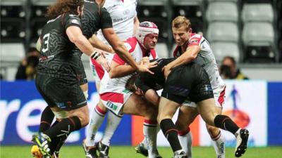 Ulster's Rory Best and Paul Marshall tackle Jeffrey Hassler of Ospreys