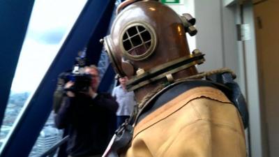 Lloyd Scott at the top of the 'Gherkin' in his 1940s diving suit