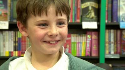 A boy in a bookshop