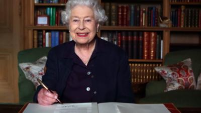 The Queen writing a message