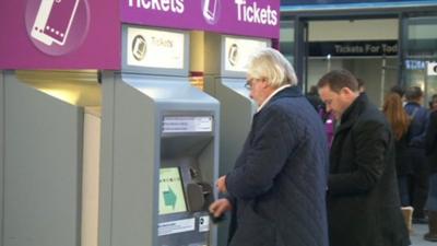 Men at automatic ticket machines