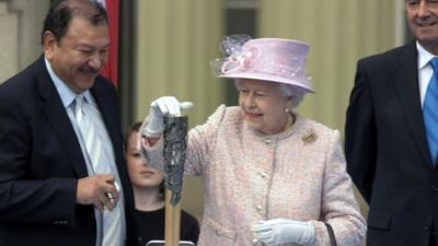 The Queen places her message inside the baton