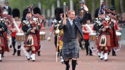 Sir Chris Hoy carrying the Commonwealth baton