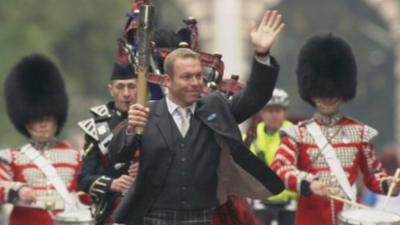 Sir Chris Hoy carries the baton