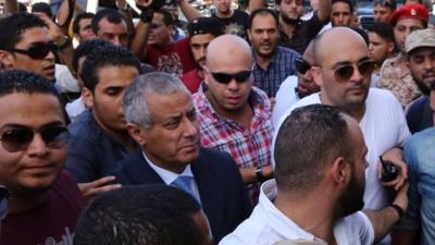 Libyan Prime Minister Ali Zeidan surrounded on his return