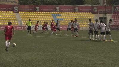 Footballers on pitch in Afghanistan