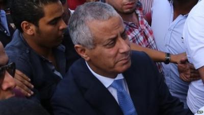 Libyan Prime Minister Ali Zeidan (C) arrives at the government headquarters in Tripoli shortly after he was freed