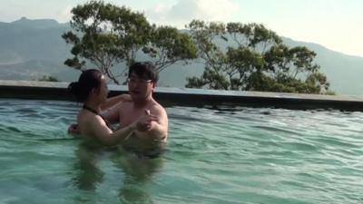 Ms Ji with a man in a swimming pool