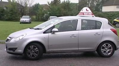 A learner driver in a car