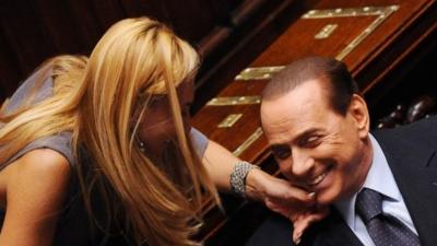 Italian MP Michaela Biancofiore (L) squeezes Italian Prime Minister Silvio Berlusconi"s chin at the Parliament in Rome, 3 August 2011