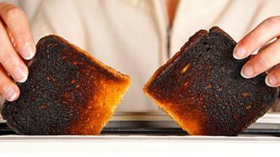 Taking burnt toast out of a toaster