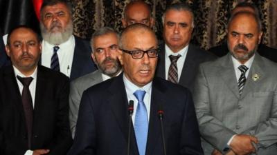 Libyan PM Ali Zeidan (centre) addresses the nation