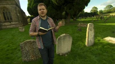 Poet Mark Grist reading his poem in a graveyard