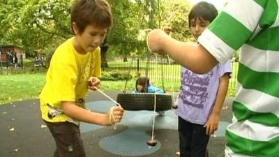 A boy swings a conker