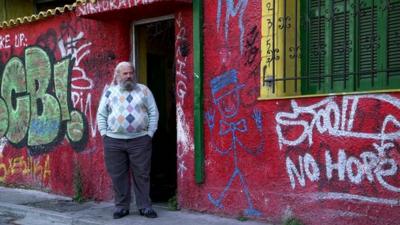 Artist Leo standing in the shelter's doorway