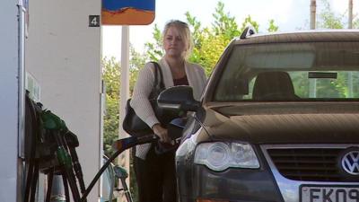 woman fills car with petrol