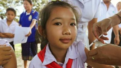A young girl in Laos, South East Asia, being injected with the HPV vaccine