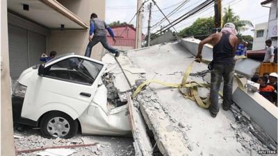 Car trapped under ruins of building