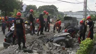 Relief workers clearing earthquake rubble