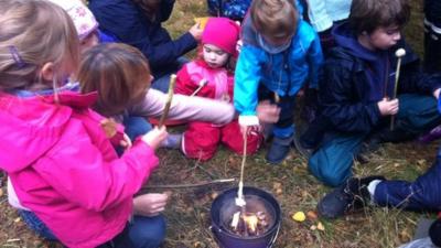 Children toasting marshmallows