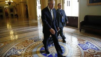 US Senate Majority Leader Harry Reid walks to his office as he arrives at the US Capitol in Washington on October 16, 2013