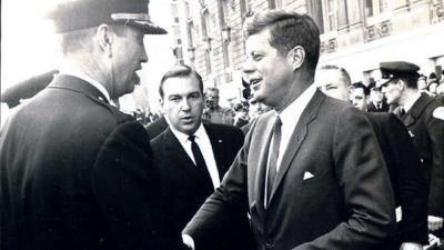 John F Kennedy with agent David Grant to rear
