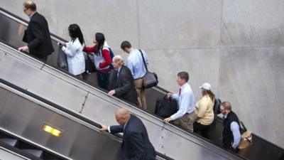 People exit a Metro subway station, by escalator, along Pennsylvania Ave., NW, in Washington, Thursday, Oct. 17, 2013