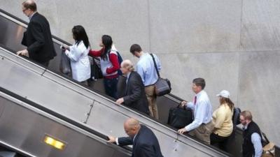 People exit a Metro subway station, by escalator, along Pennsylvania Ave., NW, in Washington, Thursday, Oct. 17, 2013