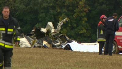 Emergency workers by wreckage of the light plane