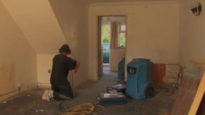 Builders repair flooded house