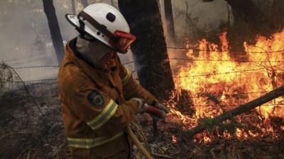 Firefighter battling a blaze in the Blue Mountains