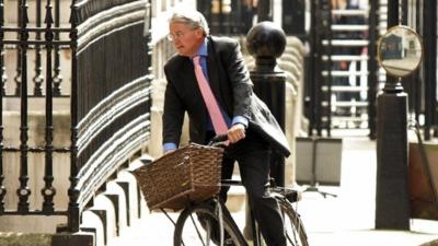 Andrew Mitchell on his bicycle in Whitehall